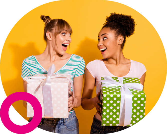 Two joyful women exchanging colorful gift boxes with surprise and excitement.